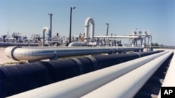 A photo provided by the Energy Department shows crude oil pipelines near Freeport, Texas.