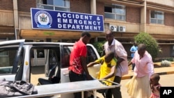 A family brings a sick relative to Parerenyatwa Hospital in Harare, Oct, 14, 2019. 