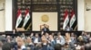 FILE - Iraqi lawmakers attend a parliamentary session to vote on the federal budget at the parliament headquarters in Baghdad, Iraq, June 11, 2023.