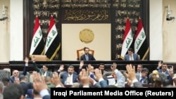 FILE - Iraqi lawmakers attend a parliamentary session to vote on the federal budget at the parliament headquarters in Baghdad, Iraq, June 11, 2023.