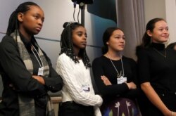 FILE - Young environmental activists Ayakha Melithafa of S. Africa, Naomi Wadler of the US, Autumn Peltier of Canada and Melati Wijsen of Indonesia take part in a forum during the World Economic Forum in Davos, Switzerland, Jan. 20, 2020.