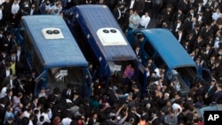 Mourners attend the funerals of Aryeh Kupinsky, Cary William Levine, and Avraham Goldberg, three of the four people killed in a shooting attack in a synagogue in Jerusalem, Nov. 18, 2014. 