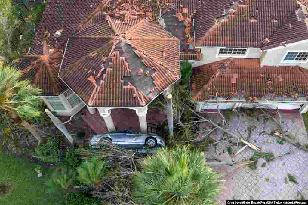 Damage to a home after a tornado ripped through The Preserve development as Hurricane Milton tracked across Florida, in Wellington, Florida.