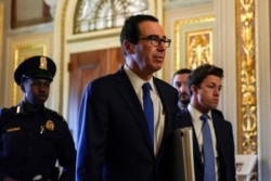 U.S. Secretary of the Treasury Steven Mnuchin walks to the meeting with Senate Minority Leader Chuck Schumer (D-NY) (not pictured) during negotiations on a coronavirus disease (COVID-19) relief package on Capitol in Washington, March 23, 2020.