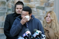 FILE - David Neumann, center, wipes his eyes as he speaks to reporters in New City, N.Y., Jan. 2, 2020, about his father, Josef Neumann, who was stabbed in an attack on a Hanukkah celebration.