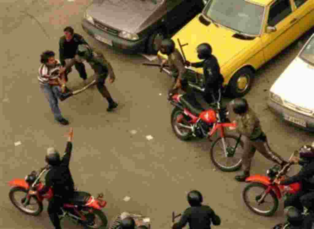 Iranian riot policemen kick a man in Zartusht street close to the Interior Ministry, as supporters of reformist candidate Mir Hossein Mousavi started to gather on the streets protesting the declared results of the Iranian presidential election in Tehran, 