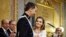 Spain's Queen Letizia holds the hands of her husband King Felipe VI during the swearing-in ceremony at the Spanish Parliament. Felipe is being formally proclaimed monarch after 76-year-old King Juan Carlos abdicated to enable younger royal blood to rally a country beset by economic problems, including an unemployment rate of 25 percent.