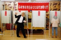 Taiwan's opposition Kuomintang Party presidential candidate Han Kuo-yu votes at a polling station during general elections in Kaohsiung, Taiwan, Jan. 11, 2020.