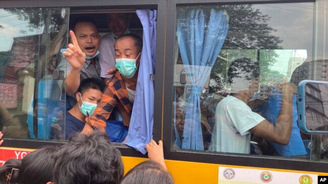 FILE - Released prisoners on a bus leave from Insein Prison in Yangon, Myanmar Wednesday, May 3, 2023.
