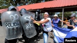 Un manifestante se enfrenta con la policía antidisturbios durante una protesta contra el gobierno del presidente nicaragüense Daniel Ortega en Managua, Nicaragua, en 2018.