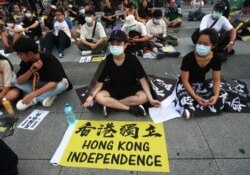 Hong Kong protesters in Taiwan and Taiwanese supporters gathered to mark the first anniversary of a mass rally in Hong Kong against its now-withdrawn extradition bil at Democracy Square in in Taipei, Taiwan, Saturday, June 13, 2020. (AP Photo/Chiang)