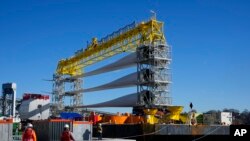 FILE - A generator and its blades are prepared to head to the ocean for the South Fork Wind farm from State Pier in New London, Conn., Monday, Dec. 4, 2023.