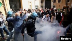 FILE - Restaurant owners clash with police as tensions rise over COVID-19 restrictions on businesses, in Rome, Italy, April 6, 2021. 