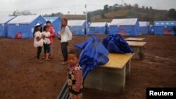 Refugees who fled fighting in neighboring Myanmar stand in a Chinese disaster relief tent camp in the town of Nansan, Yunnan province, China, March 12, 2017.