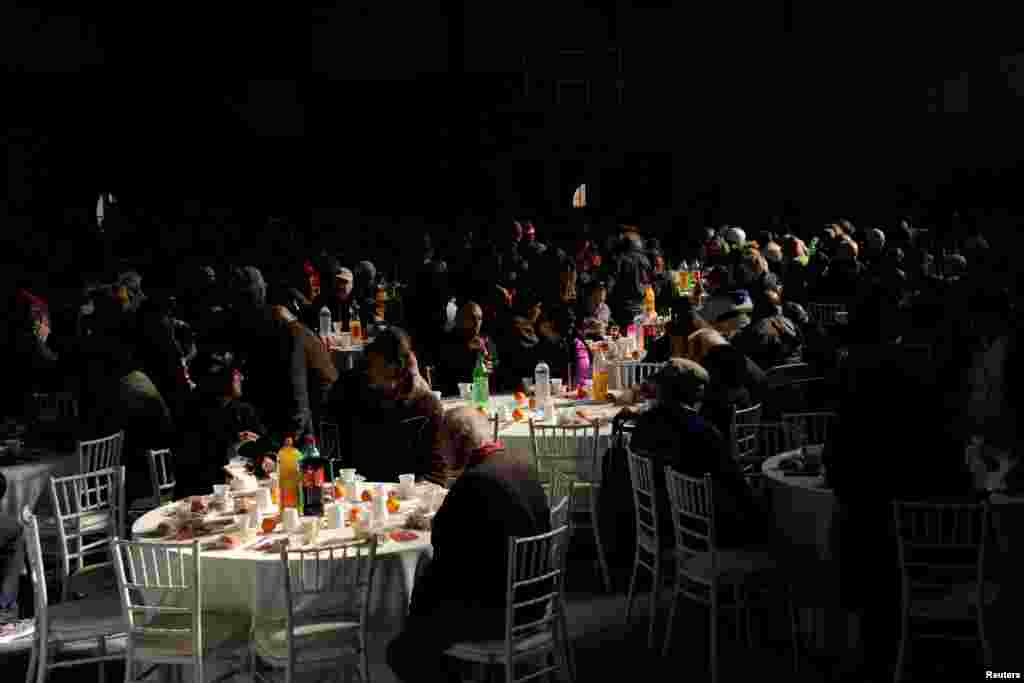 Homeless people receive a Christmas meal at an indoor gym hall in Athens, Greece, Dec. 25, 2016.