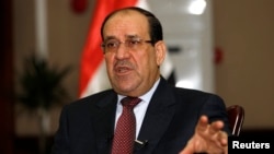 Iraq's Prime Minister Nuri al-Maliki speaks during an interview with Reuters in Baghdad, Jan. 12, 2014. 