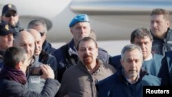 FILE- Former Italian leftist guerrilla Cesare Battisti (C) arrives at Ciampino airport in Rome, Italy, Jan. 14, 2019. 