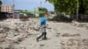 A pedestrian walks along a street in downtown Port-au-Prince, Haiti, on Sept. 23, 2024. Prime Minister Garry Conille said on Sept. 25 that Haiti is far from winning its war against the gangs that control a large part of the capital, Port-au-Prince.