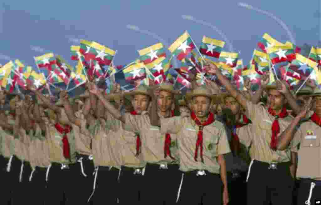 Myanmar scouts wave miniature flags as they leave the venue at a ceremony to mark the 67th anniversary of the country's Independence Day in Naypyitaw, Myanmar, Sunday, Jan. 4, 2015. (AP Photo/Khin Maung Win)