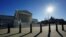 The sun casts shadows as it rises over the U.S. Supreme Court in Washington, U.S., December 20, 2023.