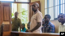 Pastor Paul Mackenzie Nthenge, who was arrested on suspicion of telling his followers to fast to death in order to meet Jesus, accompanied by some of his followers, appears at a court in Malindi, Kenya on April 17, 2023. 