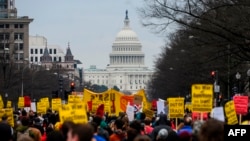 Anti-war activist march from the White House to the Trump International Hotel in Washington, DC, on January 4, 2020. - Demonstrators are protesting the US drone attack which killed Iran's Major General Qasem Soleimani in Iraq on January 3, a…