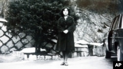 In this undated photo released Nov. 17, 2004, by the Tokyo-based National Association for the Rescue of Japanese Kidnapped by North Korea, Megumi Yokota stands by a car at an unknown place in North Korea after her abduction from her hometown in Japan. 