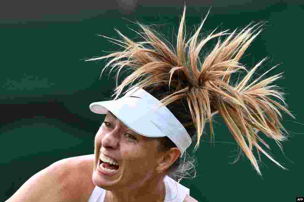 Russia's Maria Sharapova serves against France's Pauline Parmentier during their women's singles first round match on the second day of the 2019 Wimbledon Championships at The All England Lawn Tennis Club in Wimbledon, southwest London.