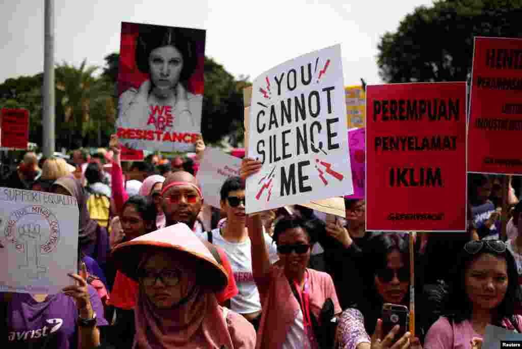 People take part in a rally calling for women's rights and equality ahead of International Women's Day in Jakarta, Indonesia.