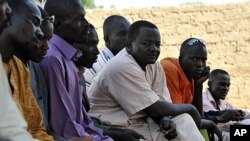 Nigerian men who recently left war-torn Libya rest after arriving to their village, Dofalis, 190km away from Niamey, on September 8, 2011.