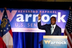 FILE - Raphael Warnock, a Democratic candidate for the U.S. Senate, speaks during a rally in Atlanta, Georgia, Nov. 3, 2020.