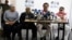 FILE - Chief negotiator of the Revolutionary Armed Forces of Colombia, or FARC, Ivan Marquez, second right, talks to reporters during a press conference in Bogota, Colombia, Dec. 6, 2016. 