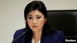 FILE - Prime Minister Yingluck Shinawatra attends her cabinet economic meeting at the office of the Permanent Secretary of Defense in Bangkok.