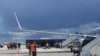 FILE - Airport personnel and security forces are seen on the tarmac in front of a Ryanair flight which was forced to land in Minsk, Belarus, May 23, 2021.