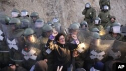 German army soldiers serving in the NATO peacekeeping mission in Kosovo clash with Kosovo Serbs on a roadblock near the village of Jagnjenica, Kosovo, early Oct. 20, 2011.