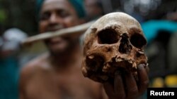 A farmer from Tamil Nadu state shows a skull, who he says are the remains of a Tamil farmer who took his own life. The living farmer is at a protest demanding good rates for their crops among other things in New Delhi, India on July 17, 2017.