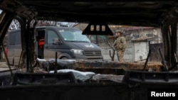 A member of the White Angel unit of Ukrainian police officers checks an area for drones as they try to persuade residents to evacuate, in the front-line town of Pokrovsk in Donetsk region, Ukraine, Feb. 6, 2025.