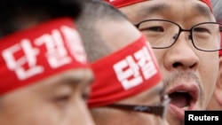 FILE - Han Sang-gyun (R) speaks at a protest in Pyeongtaek, about 70 km (43 miles) south of Seoul.