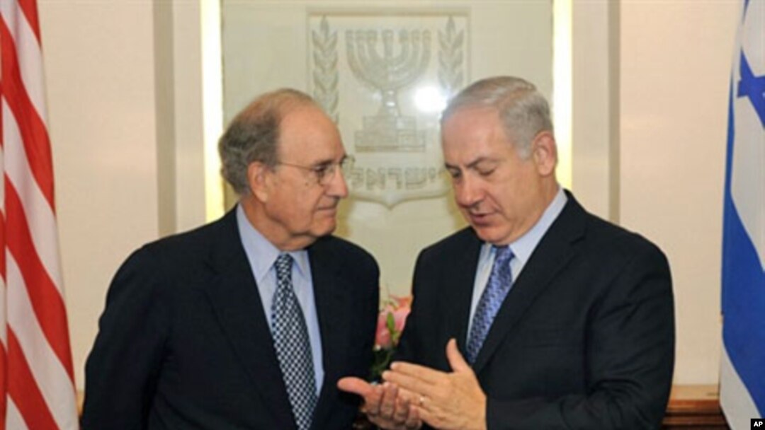 A handout picture released by the US Embassy in Israel shows US Middle East envoy George Mitchell (L) listening to Israeli Prime Minister Benjamin Netanyahu during a meeting in Jerusalem, 20 May 2010