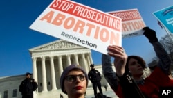 FILE - Abortion rights activists protest outside of the U.S. Supreme Court, during the March for Life in Washington, Jan. 18, 2019. 