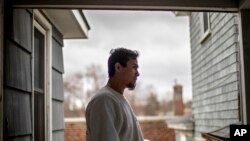 House painter Jose Martinez stands on his front porch in Greenfield, Mass, April 3, 2020. Martinez said a pandemic stimulus check could have helped cover at least a month's worth of expenses, if he had qualified.