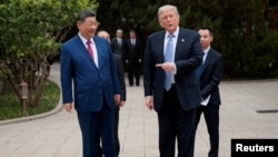 资料照片：美国总统唐纳德·特朗普在中国北京中南海花园参观结束后离开时向与中国国家主席习近平致意。(2026年5月15日)