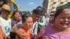 Released prisoners, front center and right, are welcomed by family members and colleagues outside Insein Prison, Jan. 4, 2025, in Yangon, Myanmar.