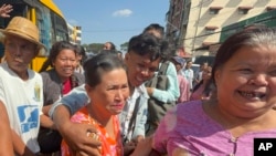 Released prisoners, front center and right, are welcomed by family members and colleagues outside Insein Prison, Jan. 4, 2025, in Yangon, Myanmar.