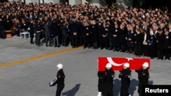 Turkish police officers carry a coffin of a fellow officer during a ceremony for police officers killed in Saturday's blasts in Istanbul, Dec. 11, 2016. 