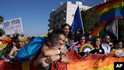 Thousands of people march under heavy security in the annual Pride Parade, in Jerusalem, Thursday, June 2, 2022. Israeli police say they arrested a man on Thursday suspected of sending death threats to an organizer of the annual Jerusalem Pride Parade. (AP Photo/Maya Alleruzzo)