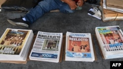 FILE - Newspapers sit stacked the day after elections in San Salvador, El Salvador, Feb. 5, 2024. The work of journalists in El Salvador is becoming tougher, with an increase in efforts to harass or block them from reporting in the past year, says a media association.