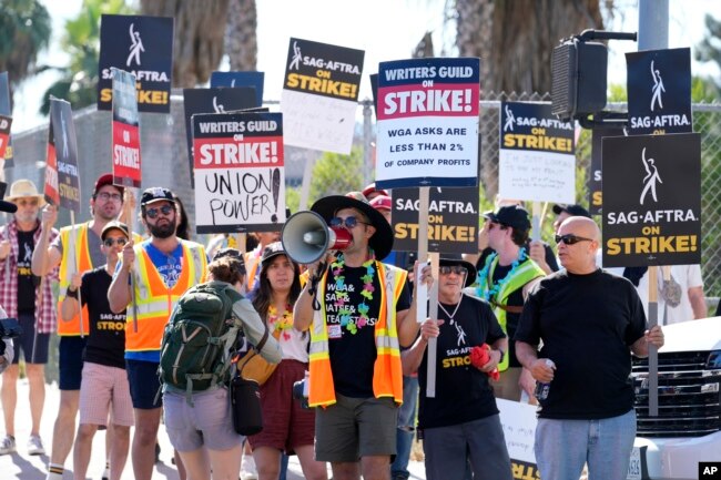 Striking writers and actors take part in a rally outside Netflix studio in Los Angeles on Friday, July 14, 2023, the day actors formally joined the picket lines, more than two months after screenwriters began striking for better pay and working conditions. (AP Photo/Chris Pizzello)