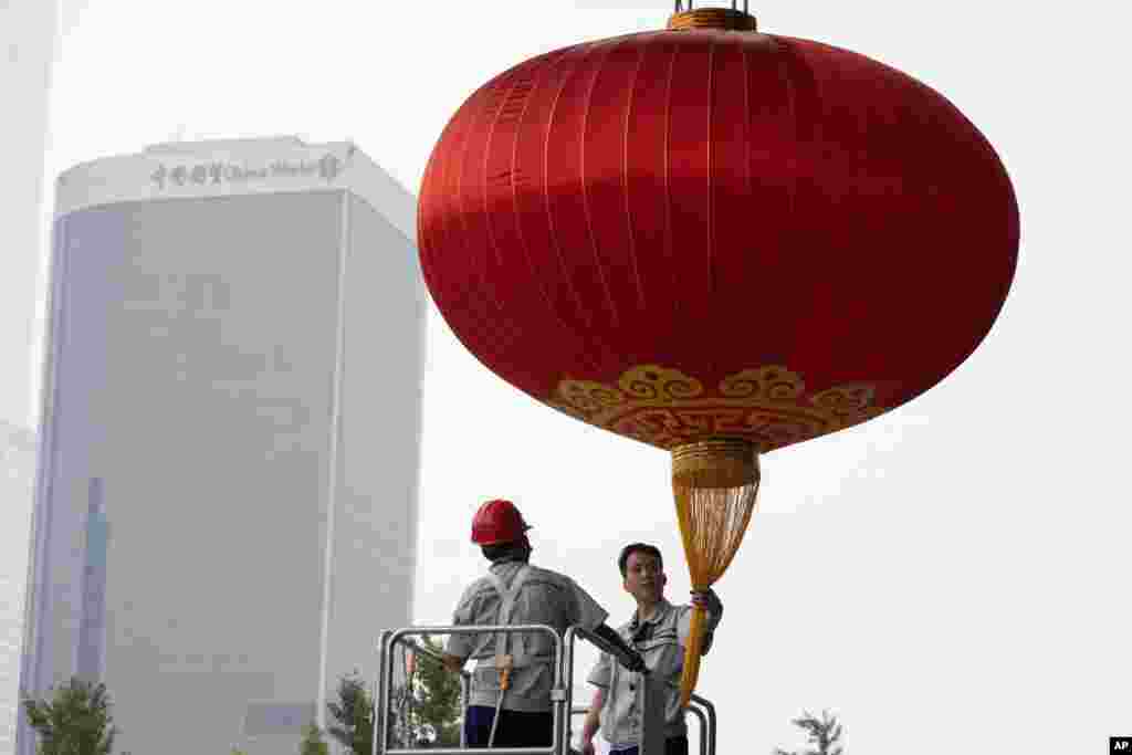 Workers prepare a giant lantern ahead of the Oct. 1 National Day holidays in Beijing, China.