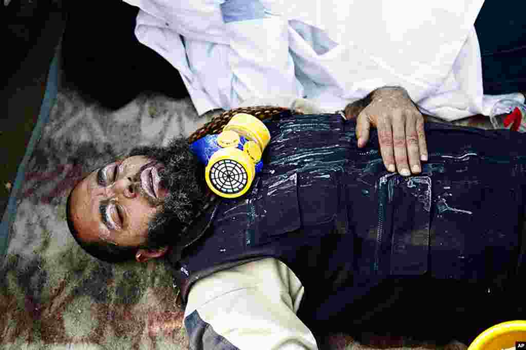 VOA - A protester recovers from exposure to tear gas on Tahrir Square, November 22, 2011. (Y. Weeks)